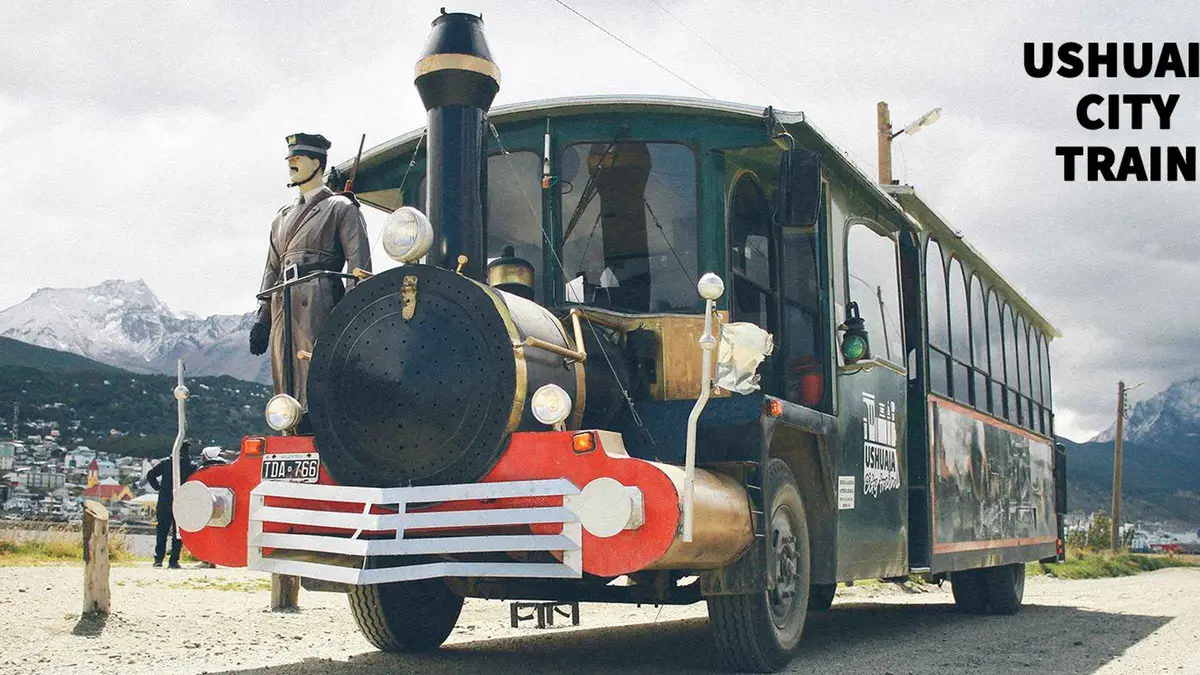 Small panoramic tourist train running along the Ushuaia waterfront below the town, Argentina