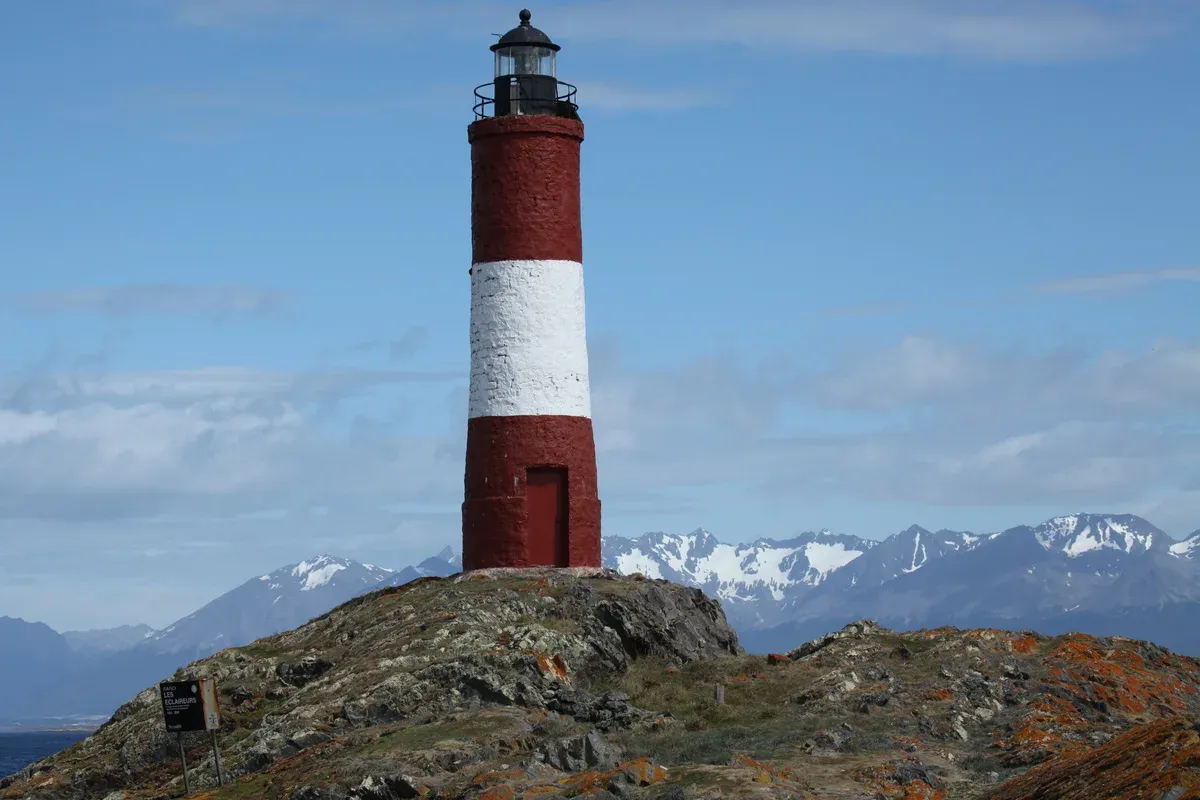 The red and white Les Eclaireurs lighthouse on its rocky islet in the Beagle Channel near Ushuaia, Argentina